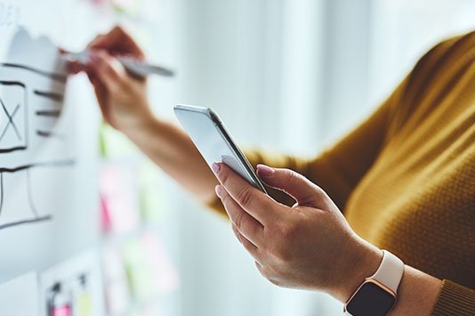 Woman working on white board