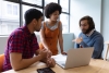 team of 3 people in front of a laptop