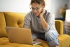 UserTesting woman sitting on sofa reading article