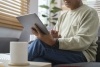 Man sitting on couch reading UserTesting guide