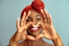 Close up of hands of African woman making heart shape. 