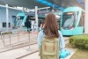 Woman traveler facing away from camera while waiting on subway train