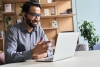 image of man smiling at laptop