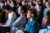 Crowd of people sitting and watching presentation