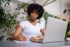 Image of a woman writing on a notepad