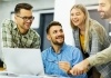 Group of young business professionals having a meeting around a laptop