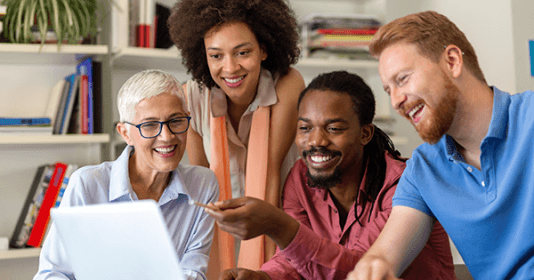 Happy coworkers looking at computer monitor